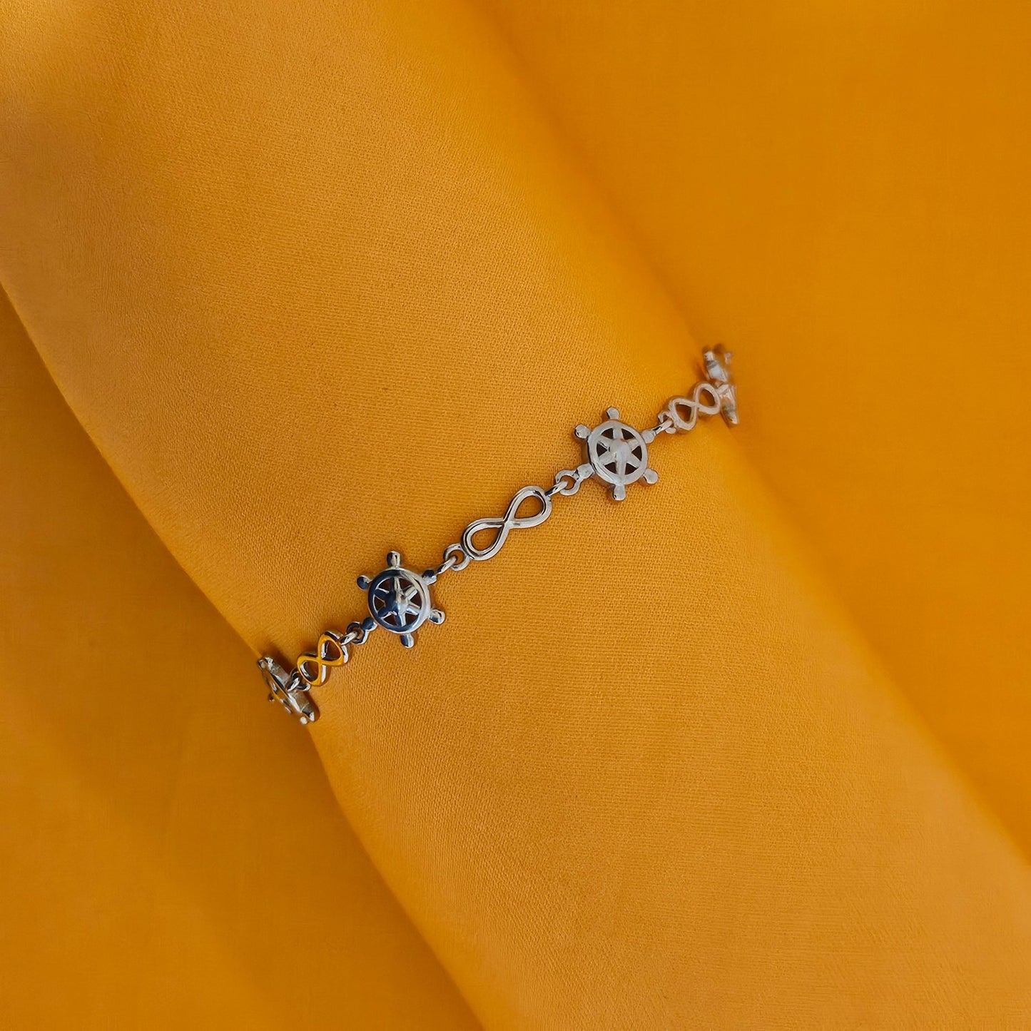 Ship wheel with infinity motif bracelet